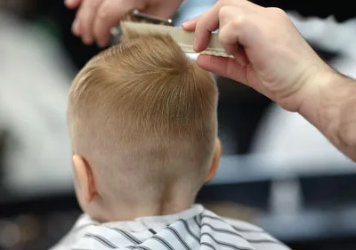 hair cuts for boys boy with blond hair having his hair cut