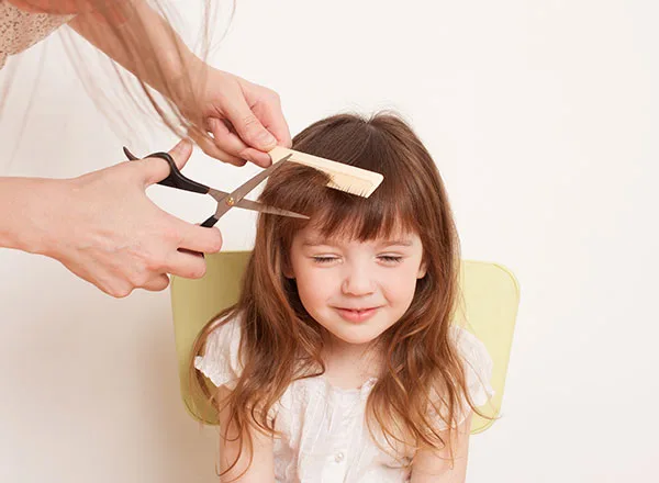 children’s haircut young girl having a hair cut