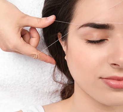 woman having threading treatment