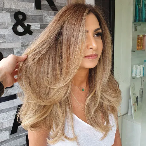 balayage treatment woman in white blouse with with blonde brown balayage