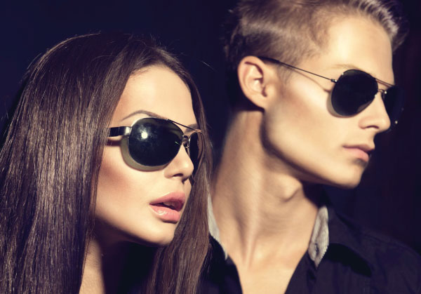 man and woman with sunglasses looking to the right