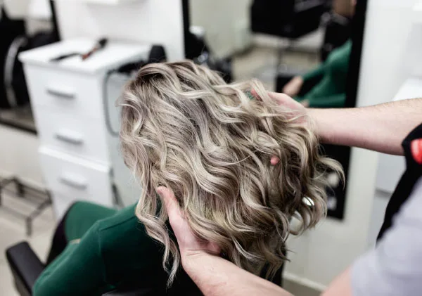 blonde balayage Woman in hair salon with blonde hair after balayage treatment