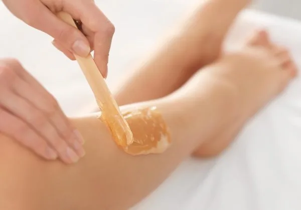 woman having leg waxed